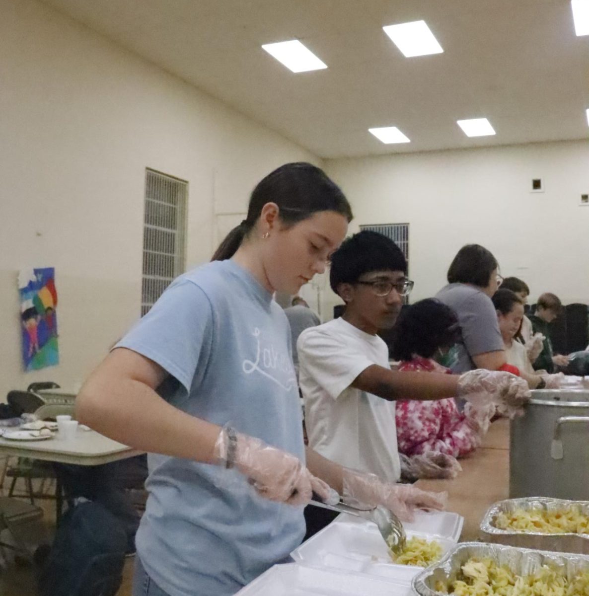 Teen volunteers serve meals at local church